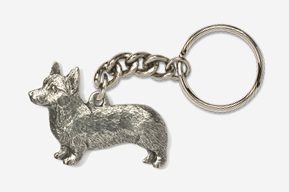 A silver key chain with a corgi dog on it.