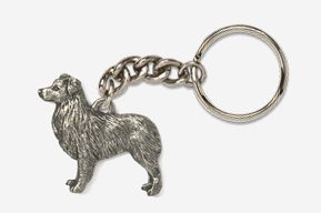 A silver key chain with a dog on it.