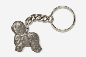 A silver key chain with a dog on it.