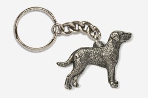 A silver key chain with a dog on it.