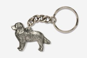 A silver key chain with a dog on it.