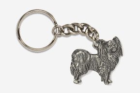 A silver key chain with a dog on it.