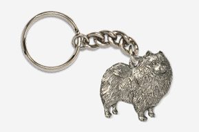 A silver key chain with a dog on it.