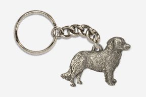 A silver key chain with a dog on it