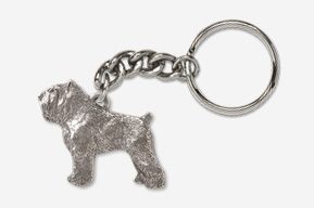 A silver key chain with a dog on it.