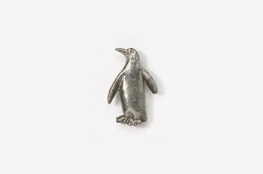 A silver penguin is sitting on the ground.