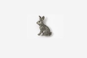 A silver rabbit sitting on top of a white table.