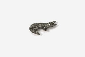 A silver alligator pin with black and white background