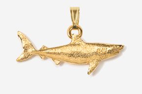 A gold shark pendant is shown in this picture.