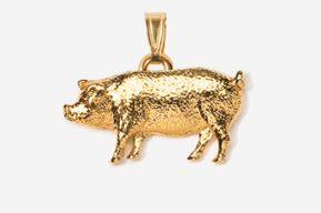 A gold pig is standing in the middle of a field.