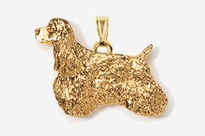 A gold colored dog pendant is shown.