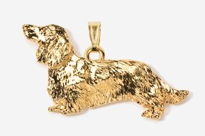 A gold plated dog pendant is shown.