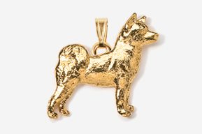 A gold colored dog pendant is shown.