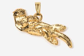 A gold pendant of a monkey hanging from the side.