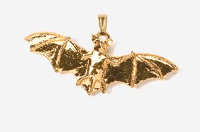 A gold bat pendant hanging from the side of its body.