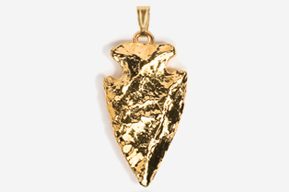 A gold arrowhead pendant is shown in this picture.