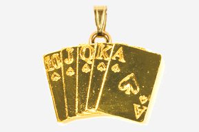 A gold pendant with four cards and the word " poker ".