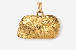 A gold pendant with a dog 's head on it.