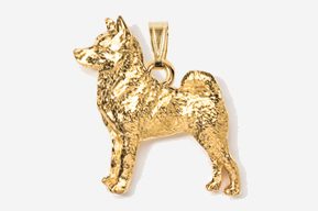 A gold dog pendant is shown in this image.