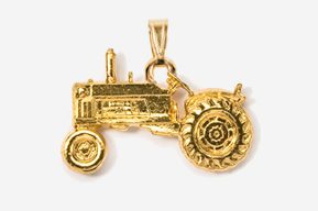 A gold tractor charm is hanging from the side of a chain.