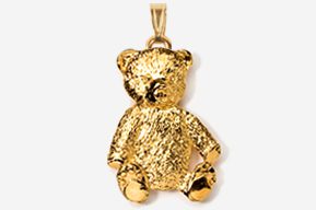 A gold teddy bear is sitting on the ground.