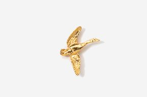 A gold bird is flying in the air.