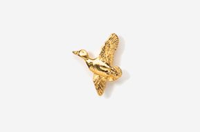 A gold bird is flying in the air.