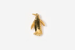 A gold penguin is standing on the ground.