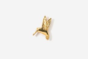 A gold hummingbird pin is shown on top of a white background.