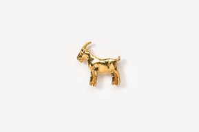 A gold goat is standing up against the wall.