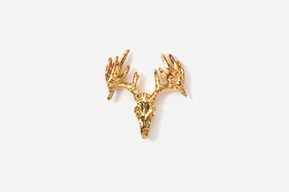 A gold deer head with antlers hanging on the wall.