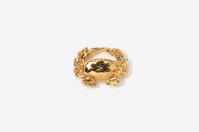 A gold crab ring is shown on a white background.